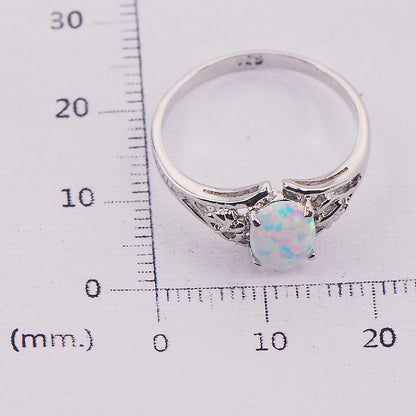 Ring CJ brand, silver-tone metal with oval multicolor opal centerpiece and side accents