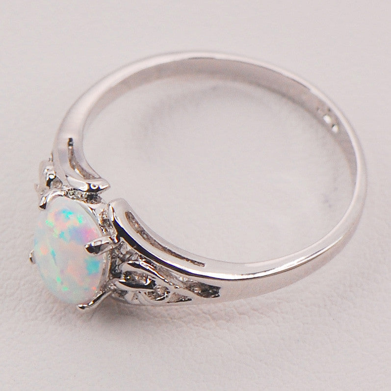 CJ opal ring, silver band with iridescent opal centerpiece