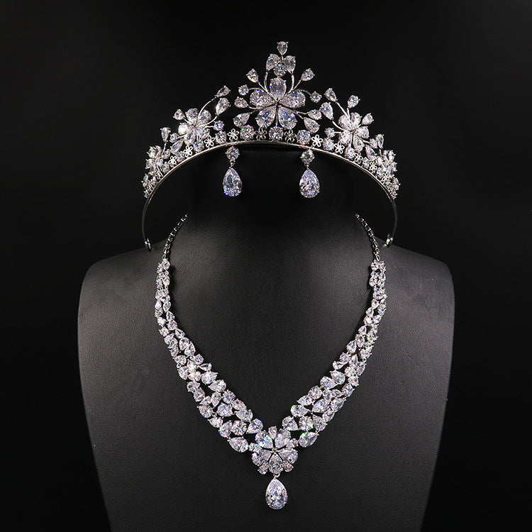 Three-piece bridal jewelry set: tiara crown, crystal necklace, and drop earrings in silver-tone crystals by CJ