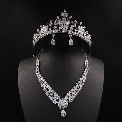 Three-piece bridal jewelry set: tiara crown, crystal necklace, and drop earrings in silver-tone crystals by CJ