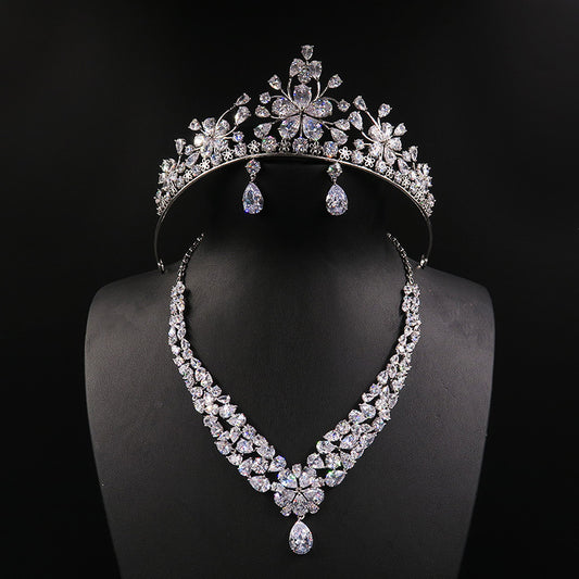 Three-piece bridal jewelry set: tiara crown, crystal necklace, and drop earrings in silver-tone crystals by CJ