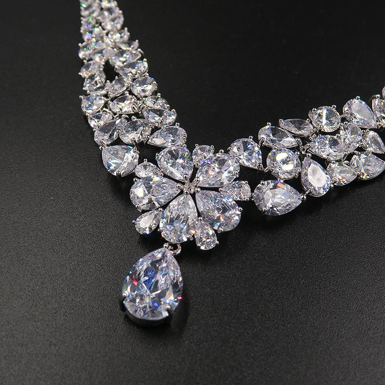 Bridal crystal necklace with flower cluster and teardrop pendant, clear stones