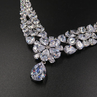Bridal crystal necklace with flower cluster and teardrop pendant, clear stones