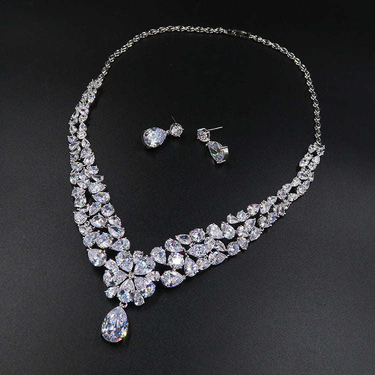 Bridal crystal necklace with teardrop pendant and matching earrings, silver-tone stones