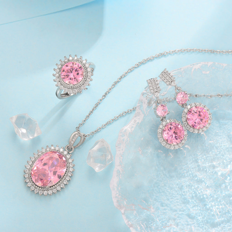 Three-piece pink crystal jewelry set by cj: silver-tone metal necklace pendant, ring, and earrings.
