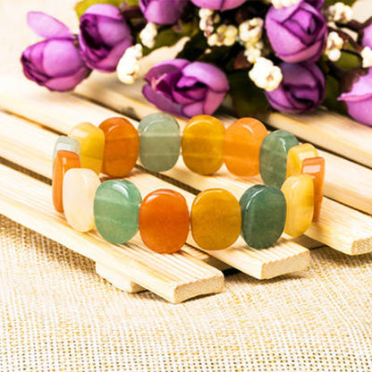 Natural crystal bracelet by cj, multicolor oval beads on a wooden display