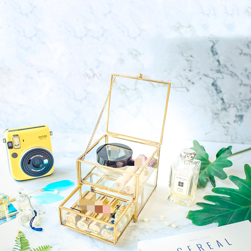 Jewelry storage box in gold-tone with glass panels, hinged lid, multi-tier display for jewelry and watches.