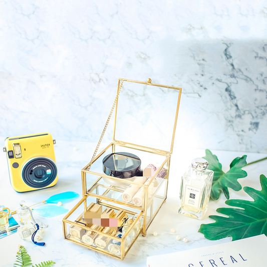 Jewelry storage box in gold-tone with glass panels, hinged lid, multi-tier display for jewelry and watches.