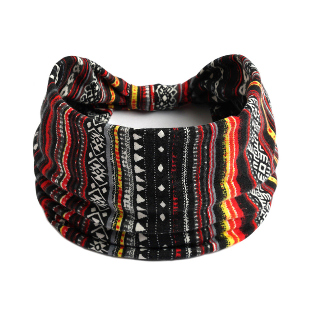 Bohemian Cashew yoga headband with red, black, white and yellow geometric pattern; absorbent antiperspirant fabric