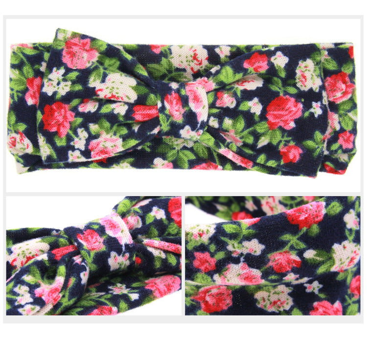 Floral children's hairband by CJ in navy with pink and white flowers and a knot bow