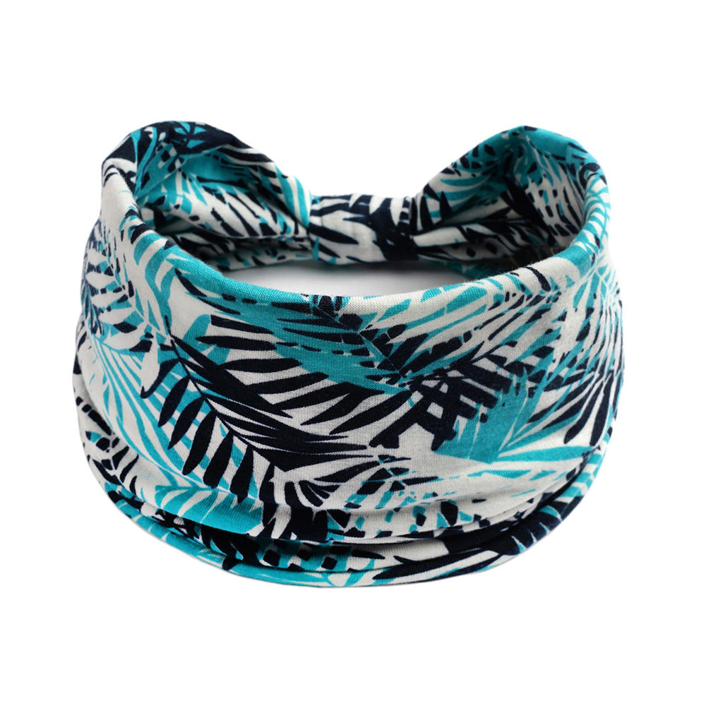 Bohemian Cashew Yoga headband with teal palm-print on white fabric, absorbent sports accessory