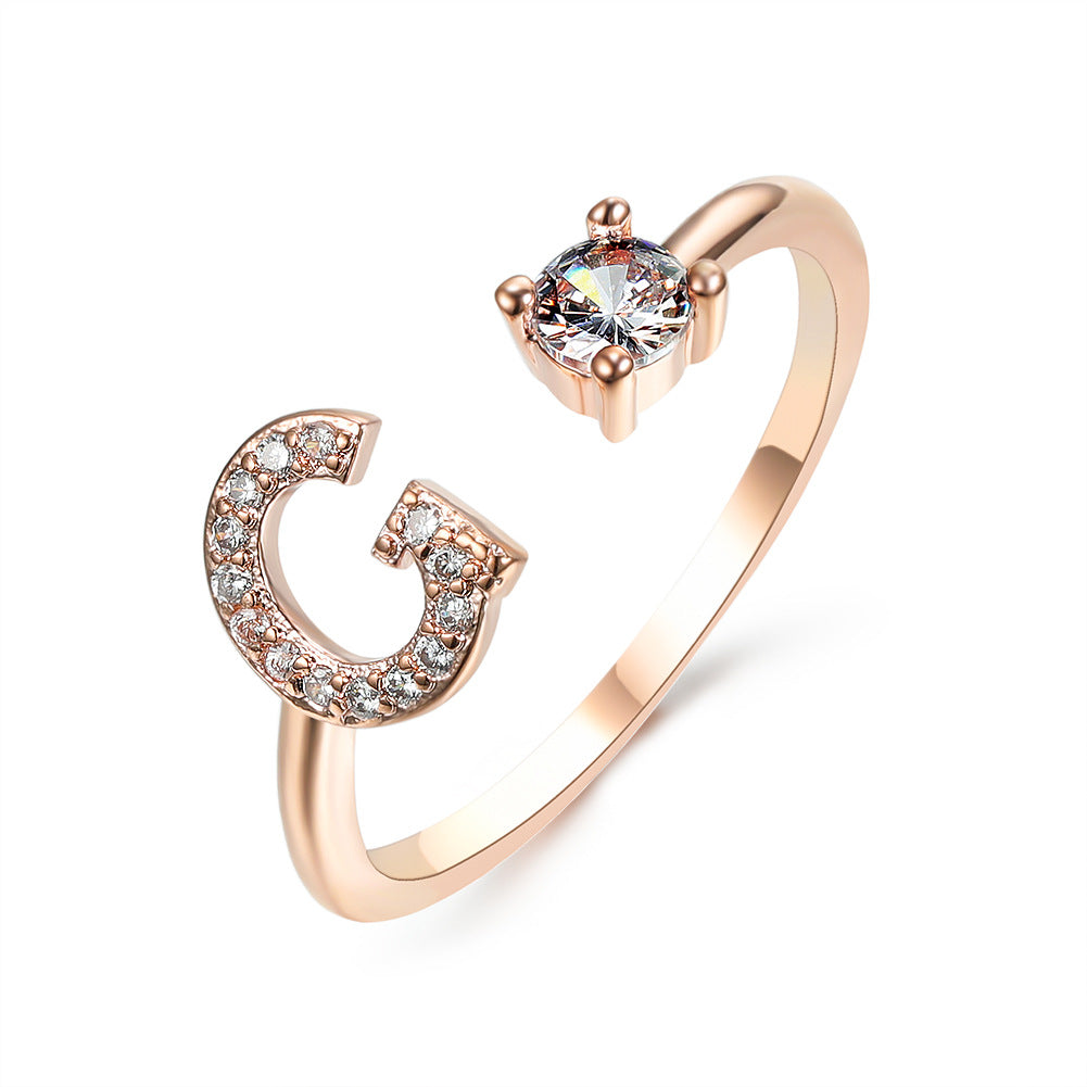 Rose gold adjustable open-ended initial G ring with pave crystals and a solitaire stone