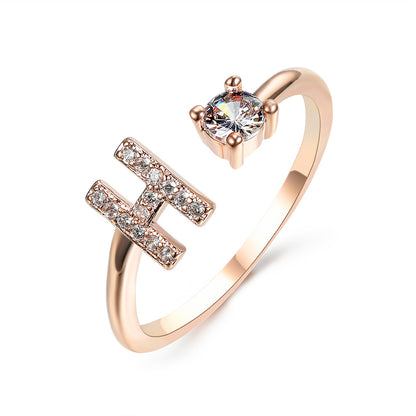 Rose gold adjustable initial-letter ring for women with diamond-studded motif and solitaire stone