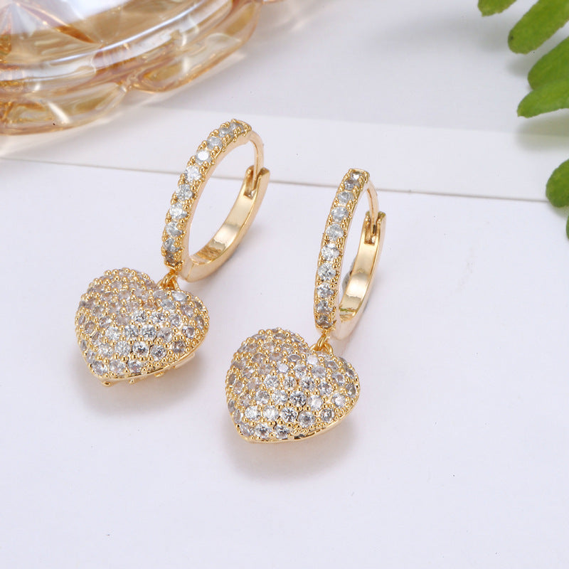 Personalized wild copper zirconium diamond earrings, gold-tone hoop pair with pave heart pendants.