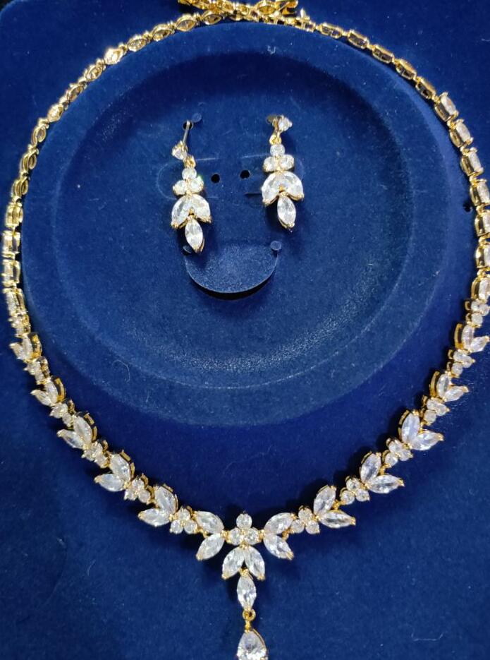 Zircon Simple Bridal Set: 3-piece gold-tone necklace with leaf-shaped stones and matching drop earrings.
