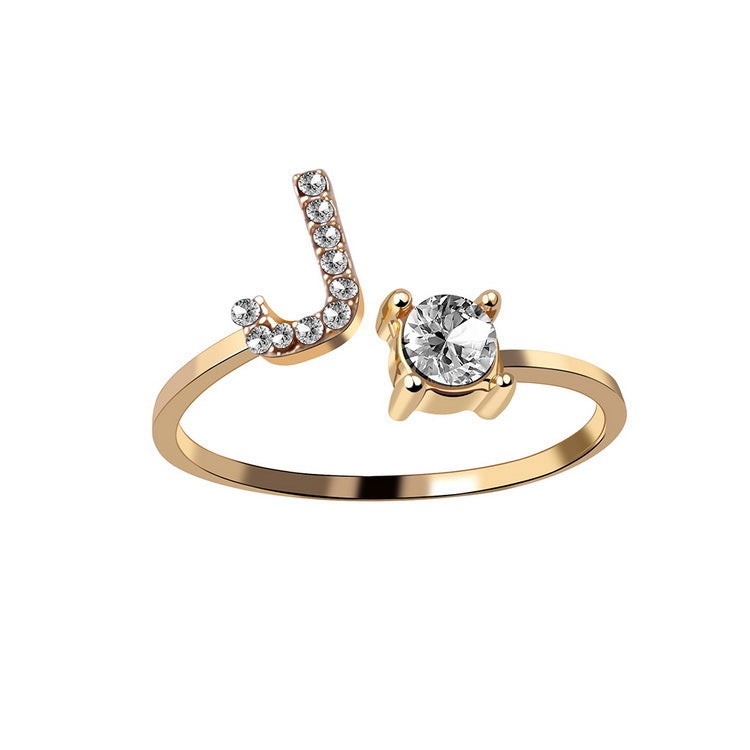 Ring, adjustable gold-tone with a solitaire diamond and crystal-studded initial J motif.