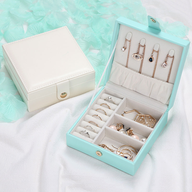 Jewelry storage box edenista turquoise PU leather square with white interior and multiple jewelry pieces