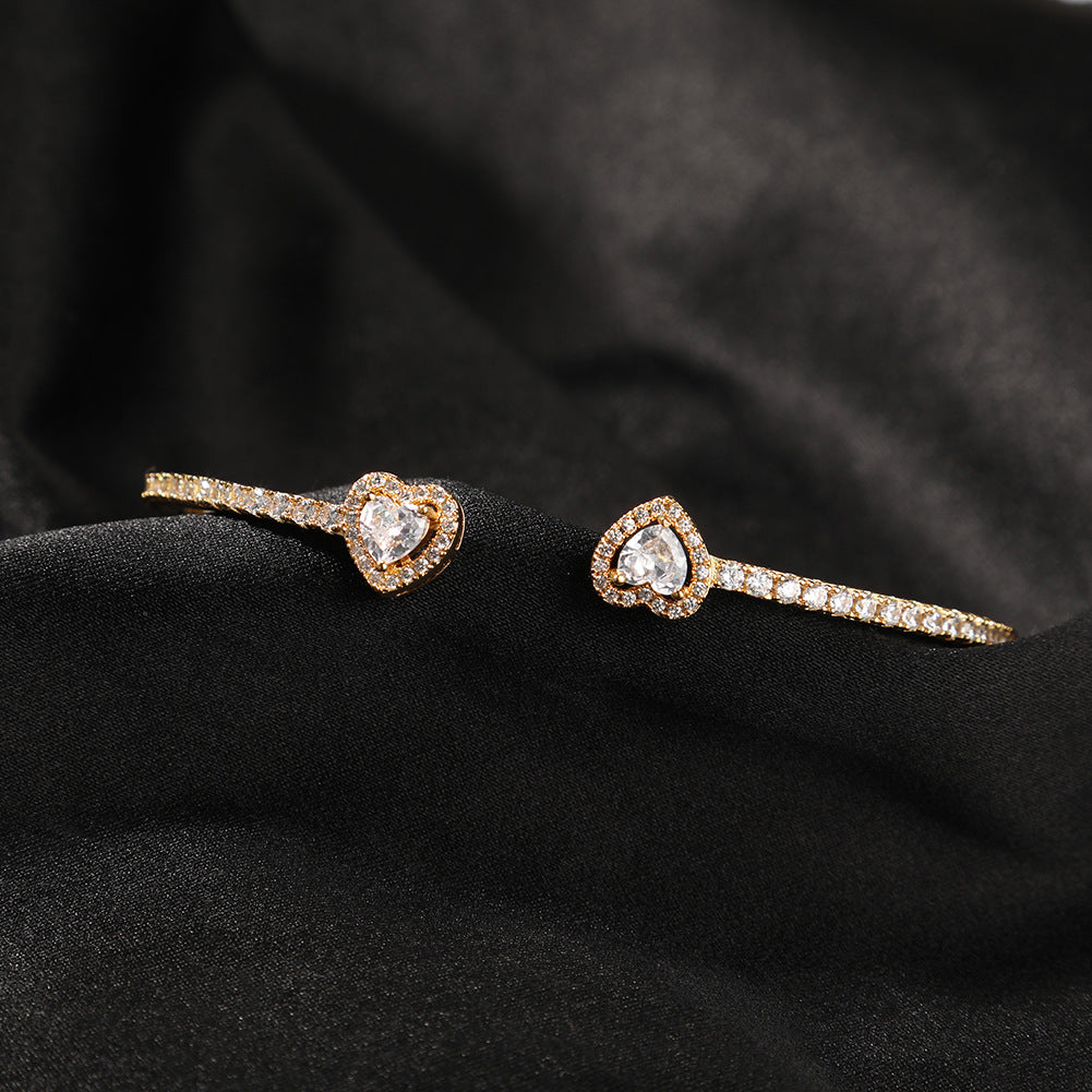 Fine circle heart-shaped diamond bracelet pair by CJ in gold-tone metal with pave diamonds