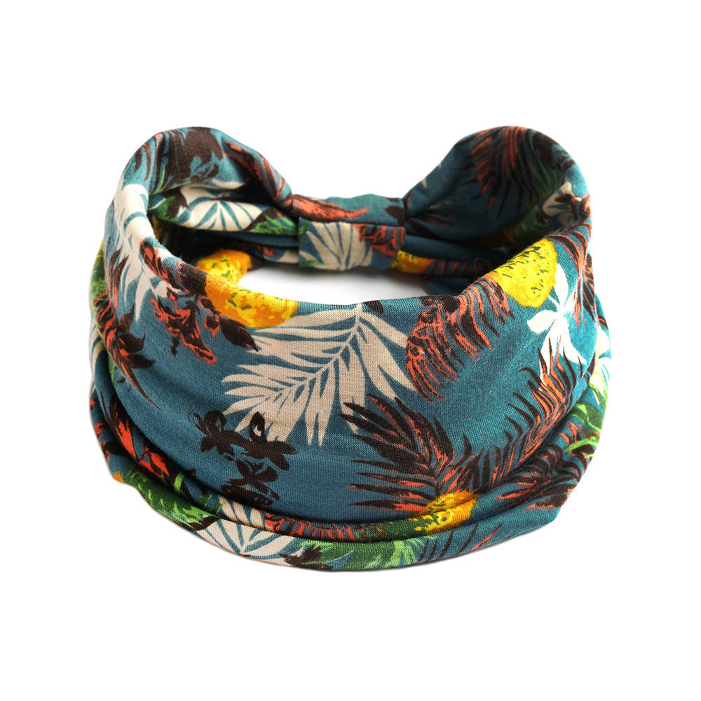Bohemian Cashew yoga headband in teal tropical print; stretchy absorbent fabric
