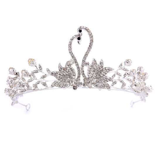 Bridal crown tiara with rhinestones and floral leaf design in silver alloy.