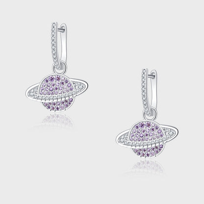 Pair of silver earrings with purple gemstones on a light gray background