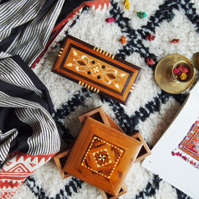 Moroccan handmade rotating wooden jewelry boxes; set of two in warm brown tones with geometric inlays.