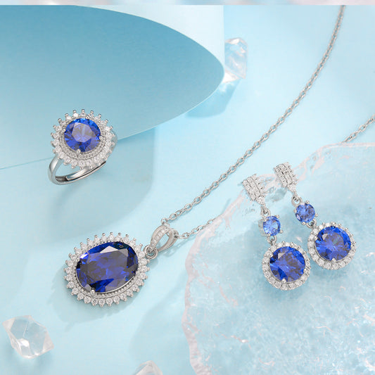 Three-piece jewelry set by cj: silver-tone with blue sapphire-like stones; ring, pendant, and earrings