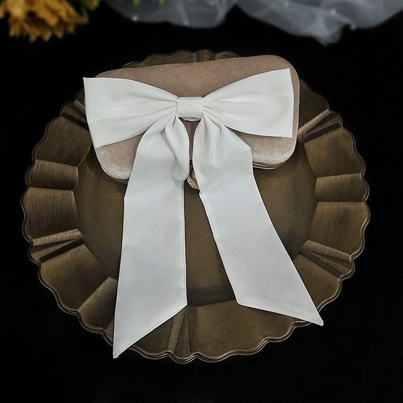 Bow Veil Super Fairy Wedding Trip Shoot by CJ; white satin bow on a scalloped brown plate