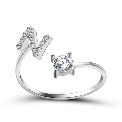 Initial letter ring set by Edenista: adjustable V-shaped pavé ring and a solitaire diamond ring