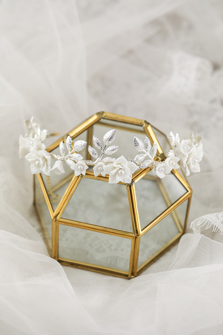 Hair band with white ceramic flowers and silver leaves on a gold-tone frame