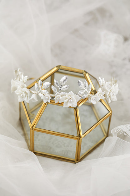 Hair band with white ceramic flowers and silver leaves on a gold-tone frame