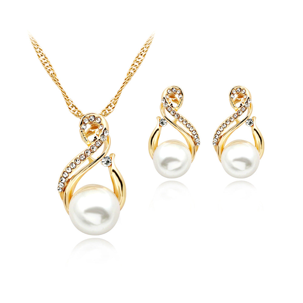 Pearl necklace and matching earrings set in gold-tone with crystal-embellished swirls and white pearls