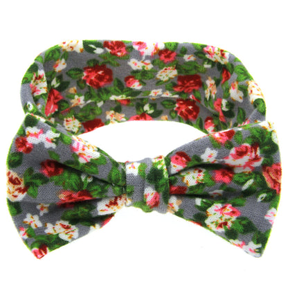 Floral children's hairband with bow; grey fabric featuring red, white, pink flowers and green leaves.
