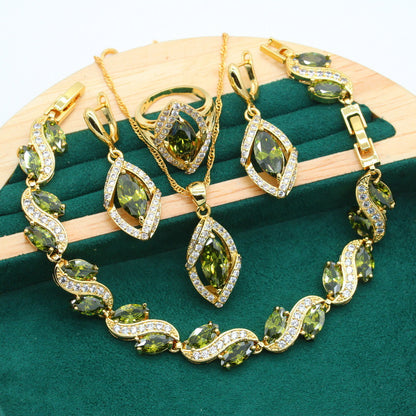 cj gold-tone four-piece zircon jewelry set with green stones: bracelet, necklace, earrings, ring