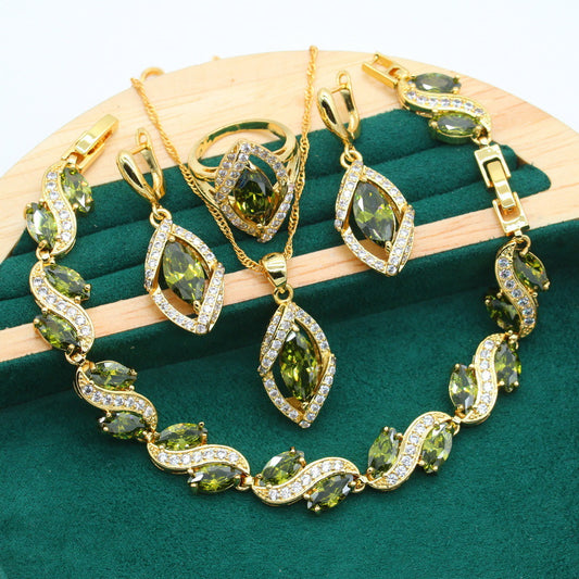 cj gold-tone four-piece zircon jewelry set with green stones: bracelet, necklace, earrings, ring