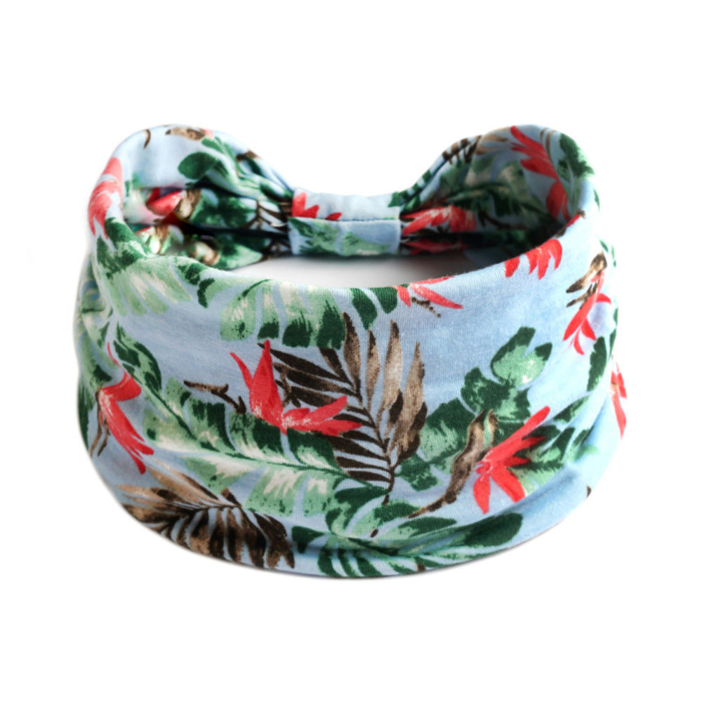 Bohemian Cashew Yoga Sports Headband in light blue tropical print with green leaves; cj brand