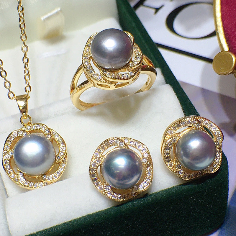 Freshwater pearl jewelry set in gold-tone with pave halos; includes necklace, ring, and a pair of grey pearl earrings.