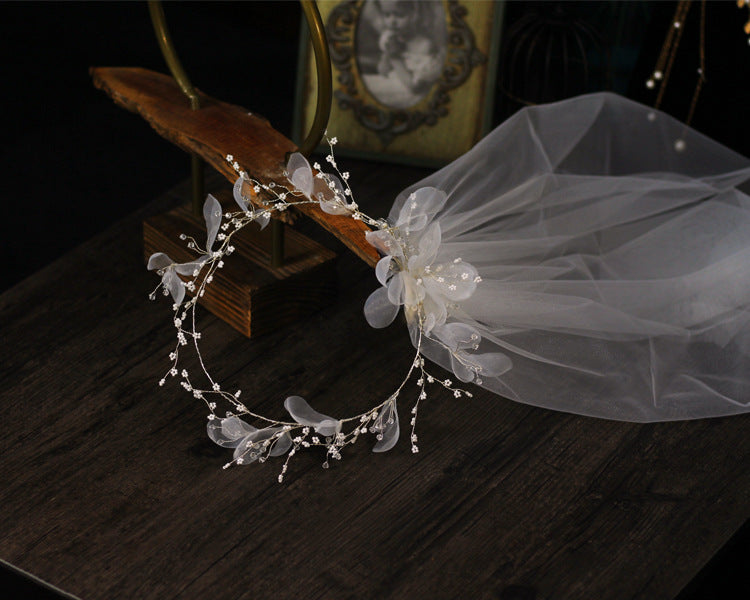 Bridal wreath headpiece with beaded floral vines and attached white tulle veil