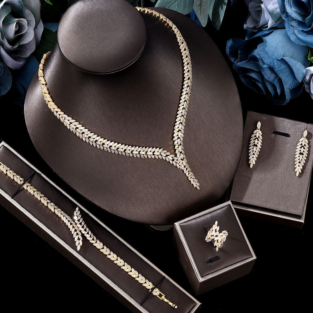 3A zircon four-piece jewelry set with gold-tone necklace, bracelet, earrings, and ring