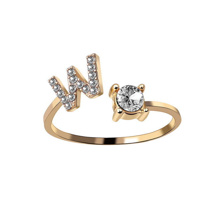 Ring, adjustable gold-tone with initial N in crystals and a solitaire stone