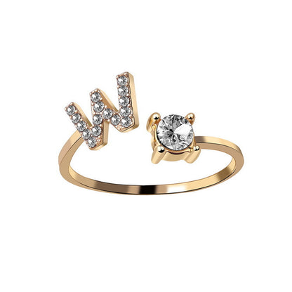 Ring, adjustable gold-tone with initial N in crystals and a solitaire stone