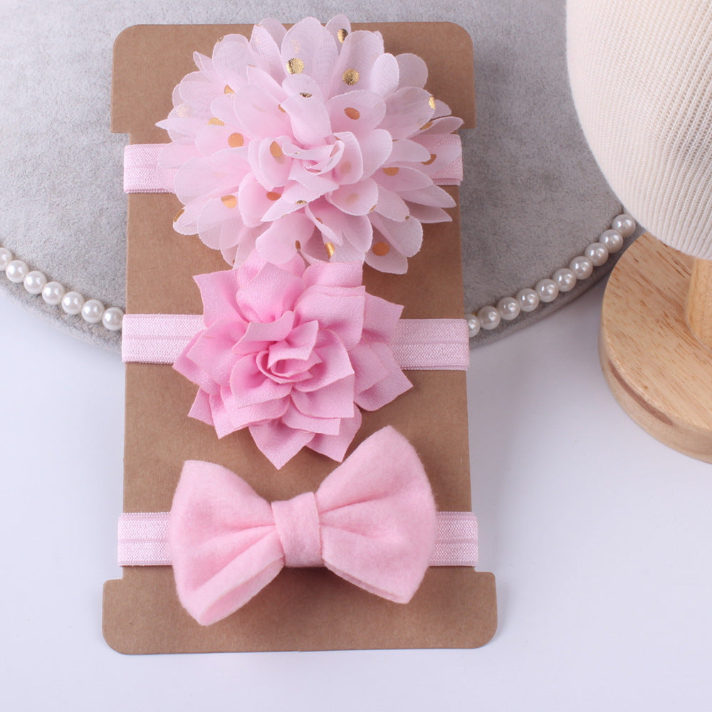 Three-piece floral pink baby stretch hairbands set on elastic with pink fabric bow and pink floral accents.