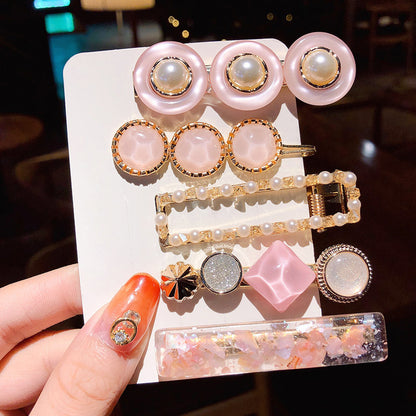 Girl's Simple Pearl Clip Set; 11-piece pink pearl clips with gold accents and pearl barrettes.