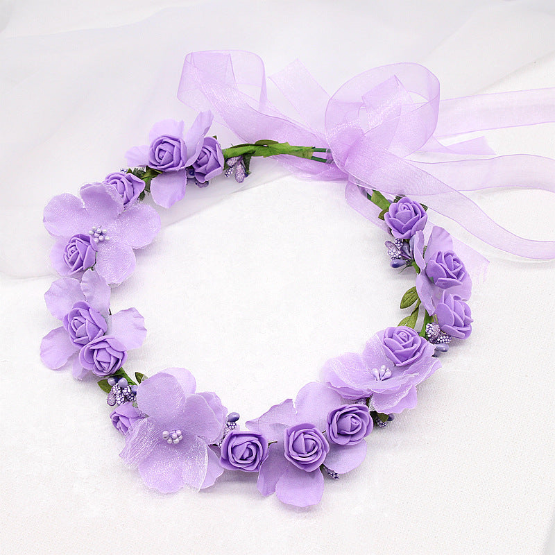 Bridal hair wreath with purple artificial flowers and lilac ribbon