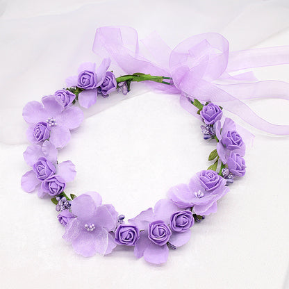 Bridal hair wreath with purple artificial flowers and lilac ribbon