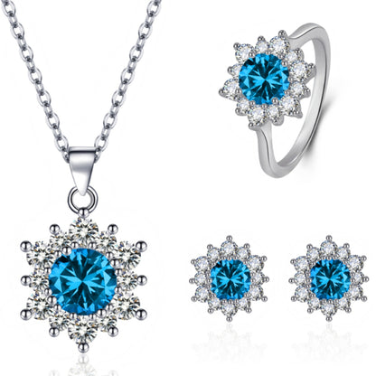 Snowflake diamond jewelry set by cj with blue center stones and crystal halos; necklace pendant, ring, and stud earrings