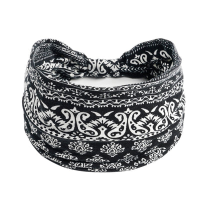 Yoga headband with black-and-white paisley bohemian print, stretchy fabric.