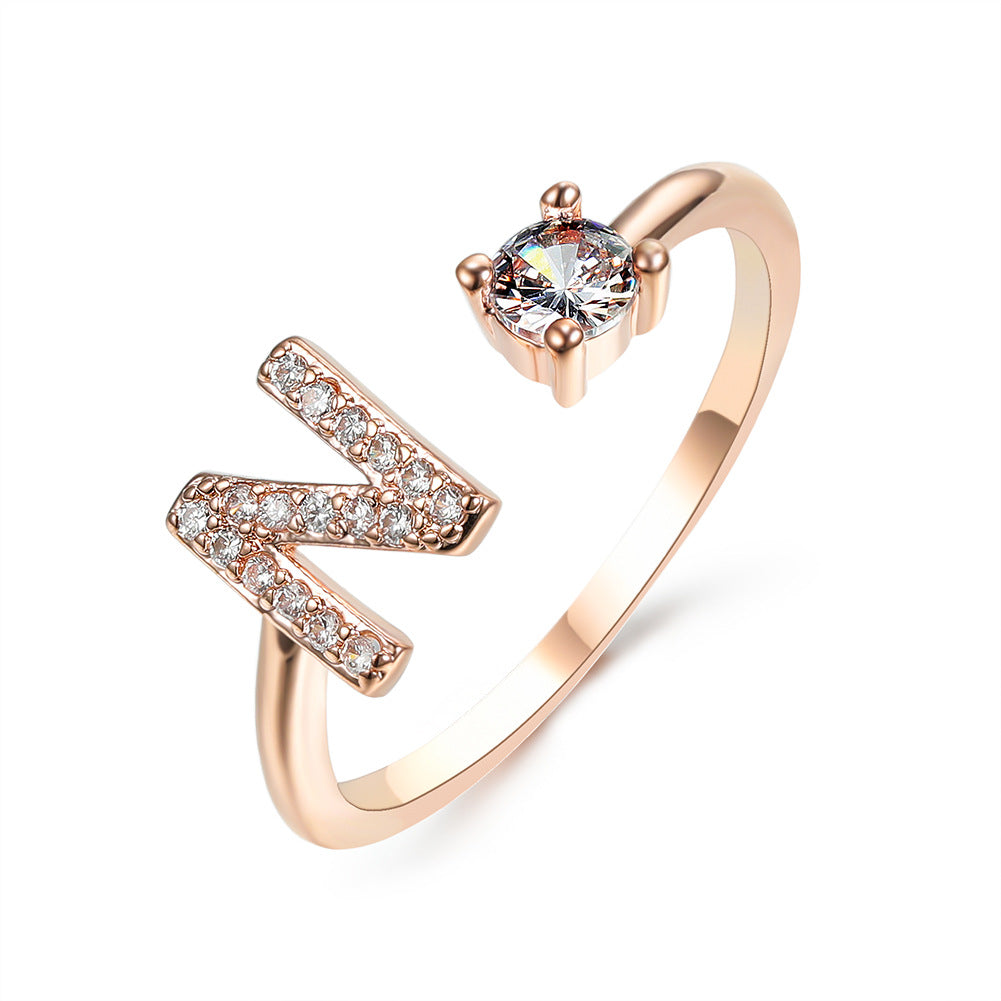 Ring, rose gold adjustable N initial letter with pave stones and a solitaire crystal.