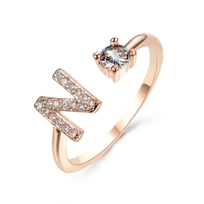 Ring, rose gold adjustable N initial letter with pave stones and a solitaire crystal.