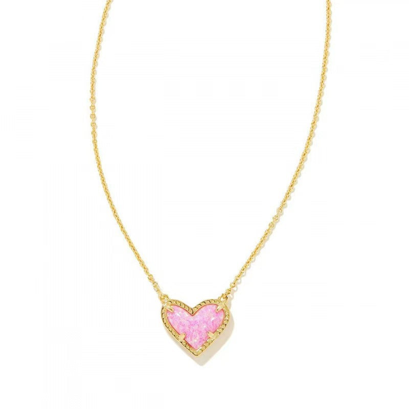 Cubic Zirconia Heart Pendant Necklace in gold-tone with pink heart charm on delicate chain.